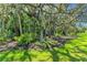 Beautiful garden with mature trees, lush tropical landscaping and striking statuary, for an inspiring setting at 1110 79Th E St, Palmetto, FL 34221