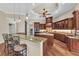 Open-concept kitchen with a large island, breakfast bar, and custom wood cabinetry at 1110 79Th E St, Palmetto, FL 34221