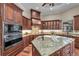 Gourmet kitchen featuring a large island, custom cabinetry, and a built-in microwave and oven at 1110 79Th E St, Palmetto, FL 34221
