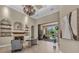 Elegant living room with a fireplace, chandelier, and views of the outdoor pool and patio at 1110 79Th E St, Palmetto, FL 34221