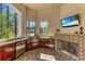 Outdoor kitchen with stainless steel appliances and a stone fireplace at 1110 79Th E St, Palmetto, FL 34221