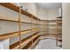 Spacious walk-in pantry with extensive wooden shelving for organized storage of food and household items at 1110 79Th E St, Palmetto, FL 34221