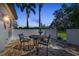 Outdoor patio with brick pavers, seating, and tropical landscaping offers a relaxing space to enjoy the outdoors at 1110 79Th E St, Palmetto, FL 34221
