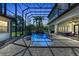 Stunning screened pool with waterfall feature, palm trees, and ample seating, perfect for relaxation and entertaining at 1110 79Th E St, Palmetto, FL 34221