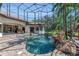 Enclosed pool features stone waterfall, spa, and lush landscaping for a relaxing outdoor oasis at 1110 79Th E St, Palmetto, FL 34221