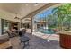 Spacious covered patio overlooking a screened-in pool with a rock waterfall feature at 1110 79Th E St, Palmetto, FL 34221
