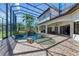 Stunning lanai featuring a sparkling pool with a rock waterfall feature at 1110 79Th E St, Palmetto, FL 34221