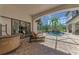 Enclosed lanai showcasing a gorgeous pool with a rock waterfall and a seating area at 1110 79Th E St, Palmetto, FL 34221