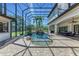 Screened-in pool area featuring a rock waterfall, lush landscaping, and ample seating at 1110 79Th E St, Palmetto, FL 34221