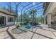 Beautiful enclosed pool area with stone patio, rock waterfall, and lush landscaping at 1110 79Th E St, Palmetto, FL 34221