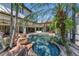 The screened pool area has a custom pool with rock waterfall and tropical landscaping, perfect for relaxation at 1110 79Th E St, Palmetto, FL 34221