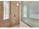 Luxurious shower with glass block window, stone tile walls, and updated fixtures creates a spa-like experience at 1110 79Th E St, Palmetto, FL 34221