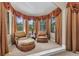 Sitting area with comfortable upholstered chairs and ottoman with plenty of natural light at 1110 79Th E St, Palmetto, FL 34221