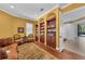 Sitting room featuring a built-in bookcase, ornate sofa, decorative rug, and arched windows with shutters at 1110 79Th E St, Palmetto, FL 34221