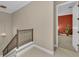 Carpeted stairway featuring a decorative railing and an open door to a room at 1110 79Th E St, Palmetto, FL 34221