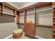 Custom walk-in closet with built-in shelving, drawers, and decorative elements offers ample storage and organization at 1110 79Th E St, Palmetto, FL 34221