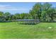 Solar panels in the yard provide eco-friendly energy, set against a backdrop of lush greenery and trees at 1110 79Th E St, Palmetto, FL 34221