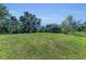 The verdant lawn has mature trees at the property line, offering privacy at 1110 79Th E St, Palmetto, FL 34221