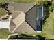 An overhead view of the home features a tile roof, landscaping and a screened-in lanai at 1118 Deardon Dr, Venice, FL 34292