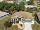 An aerial view showcases the home's well-manicured landscaping, screened-in porch and tile roof at 1118 Deardon Dr, Venice, FL 34292