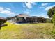 Expansive backyard featuring a screened lanai and lush green lawn for outdoor enjoyment at 1118 Deardon Dr, Venice, FL 34292