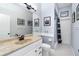 Well lit bathroom with large mirror, tile flooring, and walk in shower at 1118 Deardon Dr, Venice, FL 34292