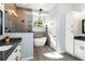 Well appointed bathroom with a frameless shower, free standing tub and dual sinks at 1118 Deardon Dr, Venice, FL 34292