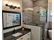 Bathroom featuring a frameless glass shower, granite countertop, and stylish vanity at 1118 Deardon Dr, Venice, FL 34292
