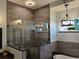 Beautiful bathroom featuring walk-in shower with frameless glass, soaking tub, and elegant lighting at 1118 Deardon Dr, Venice, FL 34292