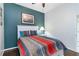 Cozy bedroom with stylish bedding, an accent wall, and plenty of natural light at 1118 Deardon Dr, Venice, FL 34292
