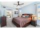 Relaxing main bedroom with a decorative ceiling fan, natural light and connected bath at 1118 Deardon Dr, Venice, FL 34292
