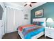 Comfortable bedroom featuring stylish bedding, and an accent wall with natural light at 1118 Deardon Dr, Venice, FL 34292