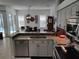 Spacious kitchen flows to dining area with stainless appliances, and granite countertops at 1118 Deardon Dr, Venice, FL 34292