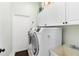 Convenient laundry room with washer, dryer, storage cabinets, and utility sink at 1118 Deardon Dr, Venice, FL 34292