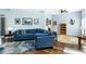 Bright living room showcasing a comfortable blue sofa and stylish decor at 1118 Deardon Dr, Venice, FL 34292
