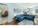 Open living area with a cozy blue sectional, seamlessly flowing into the dining area at 1118 Deardon Dr, Venice, FL 34292