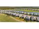 Aerial shot featuring community homes alongside a pond and golf course, creating a serene neighborhood view at 15916 Sugar Hill Dr, Punta Gorda, FL 33982