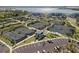 Aerial view of community tennis and pickle ball courts with parking and residential buildings surrounding a lake at 15916 Sugar Hill Dr, Punta Gorda, FL 33982