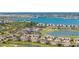 Stunning aerial view of a community with luxurious homes, a golf course, and beautiful lakes at 15916 Sugar Hill Dr, Punta Gorda, FL 33982