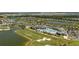 An aerial view showcasing a resort-style pool, golf course, lakes, and picturesque neighborhood at 15916 Sugar Hill Dr, Punta Gorda, FL 33982
