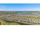 High aerial view showcasing community homes, golf course, water features, and the landscape of the area at 15916 Sugar Hill Dr, Punta Gorda, FL 33982