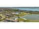 Panoramic aerial of a community with residences, golf course, clubhouse, swimming pool, and lakes at 15916 Sugar Hill Dr, Punta Gorda, FL 33982