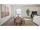 Dining area with wood table, modern decor, and seamlessly integrates with the living area at 15916 Sugar Hill Dr, Punta Gorda, FL 33982