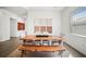Bright dining room features a wood table with white upholstered chairs and a unique wood bench at 15916 Sugar Hill Dr, Punta Gorda, FL 33982