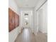 Bright entryway with wood-look tile flooring, white walls, and decorative art at 15916 Sugar Hill Dr, Punta Gorda, FL 33982