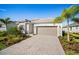Charming single Gathering home featuring a neatly paved driveway and a two car garage at 15916 Sugar Hill Dr, Punta Gorda, FL 33982