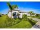 A well maintained front yard features green grass and lush landscaping at 15916 Sugar Hill Dr, Punta Gorda, FL 33982