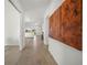 Hallway showcasing dark wood-look flooring and decorative art at 15916 Sugar Hill Dr, Punta Gorda, FL 33982