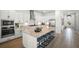 Beautiful kitchen with an island featuring an oven, stove, sink, and breakfast bar at 15916 Sugar Hill Dr, Punta Gorda, FL 33982