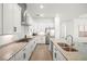 A well-lit kitchen featuring stainless steel appliances, granite countertops, and modern cabinetry at 15916 Sugar Hill Dr, Punta Gorda, FL 33982
